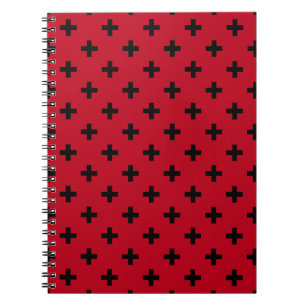 Black polka crosses on red notebook