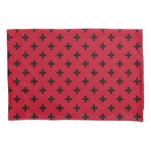 Black polka crosses on red pillowcase
