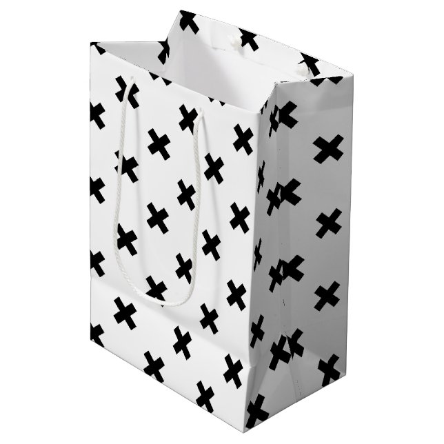 Black polka crosses on white medium gift bag (Front Angled)