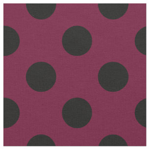 Black polka dots on burgundy fabric