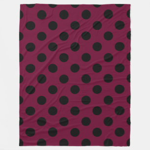 Black polka dots on burgundy fleece blanket