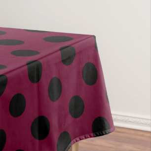 Black polka dots on burgundy tablecloth