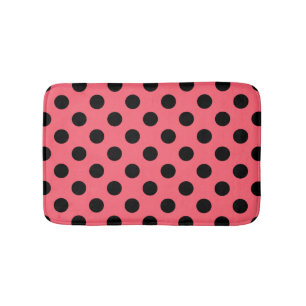 Black polka dots on coral bath mat