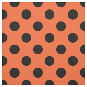 Black polka dots on orange fabric