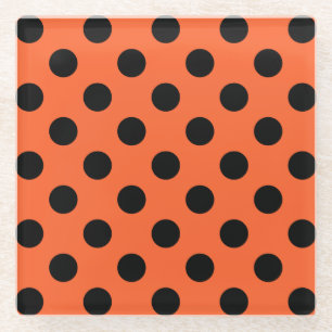 Black polka dots on orange glass coaster