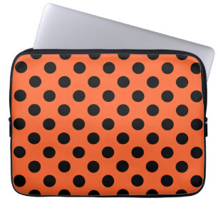 Black polka dots on orange laptop sleeve