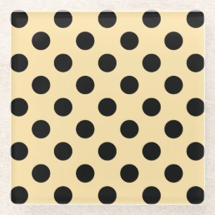 Black polka dots on pale yellow glass coaster
