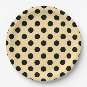 Black polka dots on pale yellow paper plate