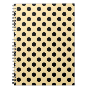 Black polka dots on pale yellow spiral notebook
