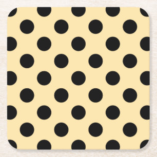 Black polka dots on pale yellow square paper coaster