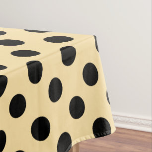 Black polka dots on pale yellow tablecloth