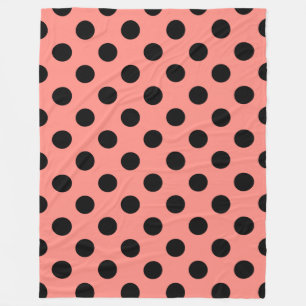 Black polka dots on peach fleece blanket