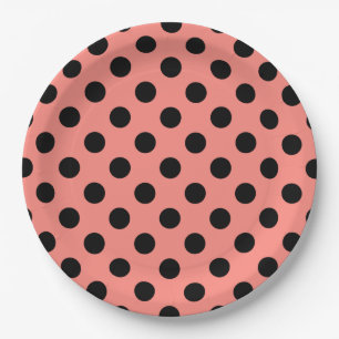 Black polka dots on peach paper plate
