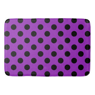 Black polka dots on purple bath mat