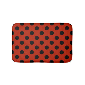 Black polka dots on red bath mat