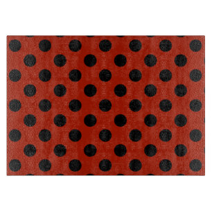 Black polka dots on red cutting board