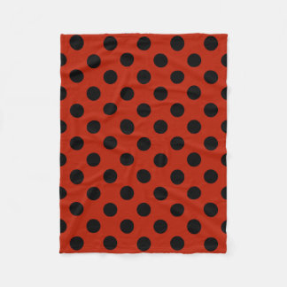 Black polka dots on red fleece blanket
