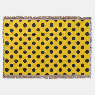 Black polka dots on yellow throw blanket