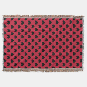 Black polka hearts on red throw blanket
