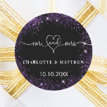 Black purple mr mrs heart wedding classic round sticker<br><div class="desc">A stylish black background,  decorated with purple faux sparkles. Mr and Mrs with a heart. Personalise and add your names and wedding date.   White text.</div>