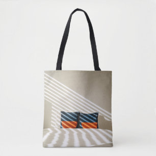 Black red and white plaid textile on white bed tote bag
