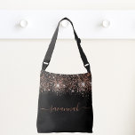 Black rose gold glitter monogram script crossbody bag<br><div class="desc">A chic black background decorated with rose gold glitter drops. Personalise and add a name. Rose gold coloured text. The name is written with a modern hand lettered style script with swashes. To keep the swashes only delete the sample name, leave the spaces or emoji's in front and after the...</div>