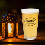 Black Stylised Wedding Groomsman Name Glass<br><div class="desc">Beer glass for the wedding groomsman that features his name printed in black,  stylised script inside a black bordered oval along with wedding date. A great party supply idea for a bachelor party! Personalise your beer glass by editing and replacing name and date with your own.</div>
