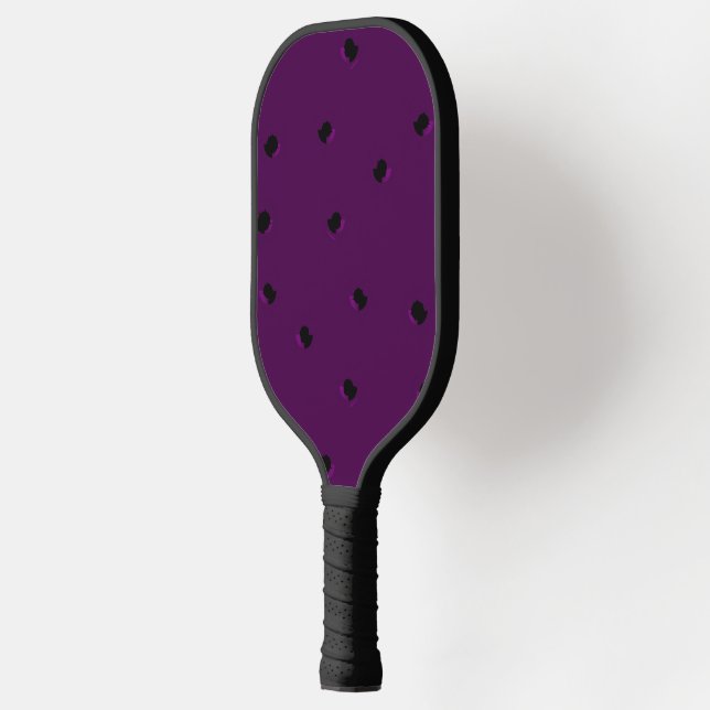 Black tiny holes on purple pickleball paddle (Left)
