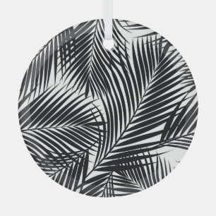 Black tropical palm leaves, white background glass tree decoration