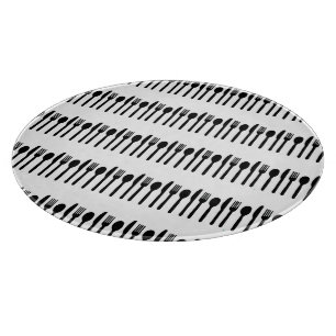 Black white eating utensils glass cutting board