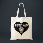 Black & White Gothic Wedding with Skull Bridesmaid Tote Bag<br><div class="desc">Designed for a Gothic wedding this bridesmaid tote bag begins with a large black heart and the word bridesmaid written in large white letters. A sugar skull is below. It has a large red flower in the centre of its forehead.</div>
