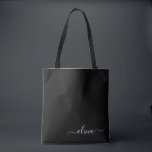 Black White Modern Minimalist Elegant Monogram Tote Bag<br><div class="desc">Introducing our Black and White Minimalist Modern Monogram Collection: Embrace simplicity and sophistication with our minimalist designs, curated to elevate your style effortlessly. Crafted with a keen eye for modern aesthetics, this collection features sleek black and white designs accentuated by personalised monograms. From chic stationery to versatile accessories, our collection...</div>
