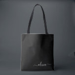Black White Modern Minimalist Elegant Monogram Tote Bag<br><div class="desc">Introducing our Black and White Minimalist Modern Monogram Collection: Embrace simplicity and sophistication with our minimalist designs, curated to elevate your style effortlessly. Crafted with a keen eye for modern aesthetics, this collection features sleek black and white designs accentuated by personalised monograms. From chic stationery to versatile accessories, our collection...</div>