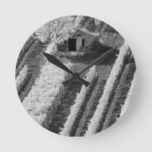 Black & White view of small stone barn Round Clock