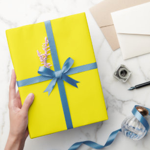 blank yellow sheet, curled at one edge wrapping paper