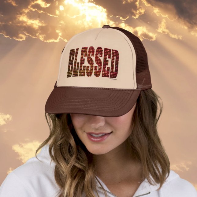 Blessed Trucker Hat –  Faux Foil Affirmation (Woman wearing tan/brown Trucker Hat that says Blessed in Faux Mettalic Letters, Rays of Light in Sky)