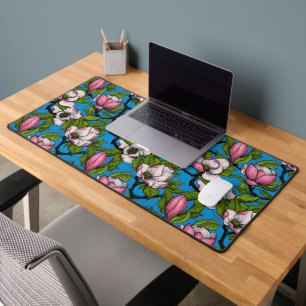 Blooming magnolia on blue desk mat