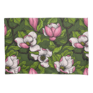 Blooming magnolia on dark green pillowcase