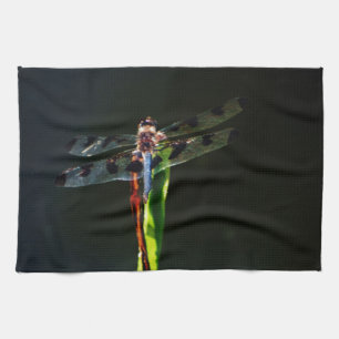 Blue and black  Dragonfly on green and red grass Tea Towel