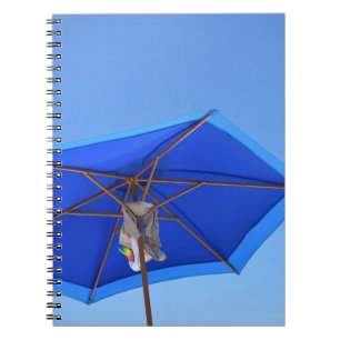 Blue and brown patio umbrella in the morning notebook