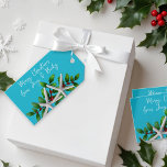Blue Beach Christmas Starfish Tie On Gift Tags<br><div class="desc">Beach Christmas gift tags with hole and twine to tie.  White starfish and green holly design,  over tropical aqua blue colour.  Customise white script with a greeting and signature.  Horizontal orientation with more starfish on the back.</div>