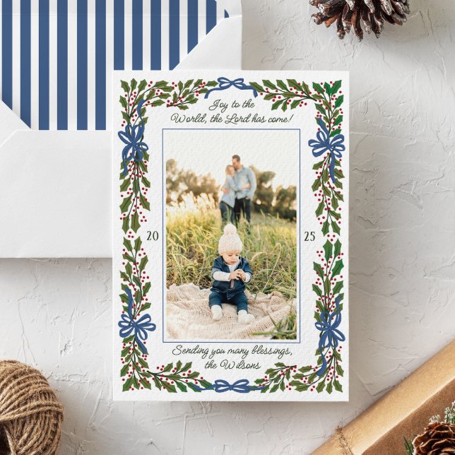 Blue Bows and Holly Garland One-Photo Christmas Holiday Card (charming illustrated boughs of holly and blue ribbon bows frame vertical photo with script text)