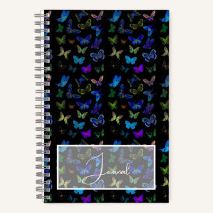 Blue butterflies on black journal