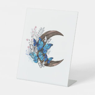 Blue butterflies on wooden crescent pedestal sign