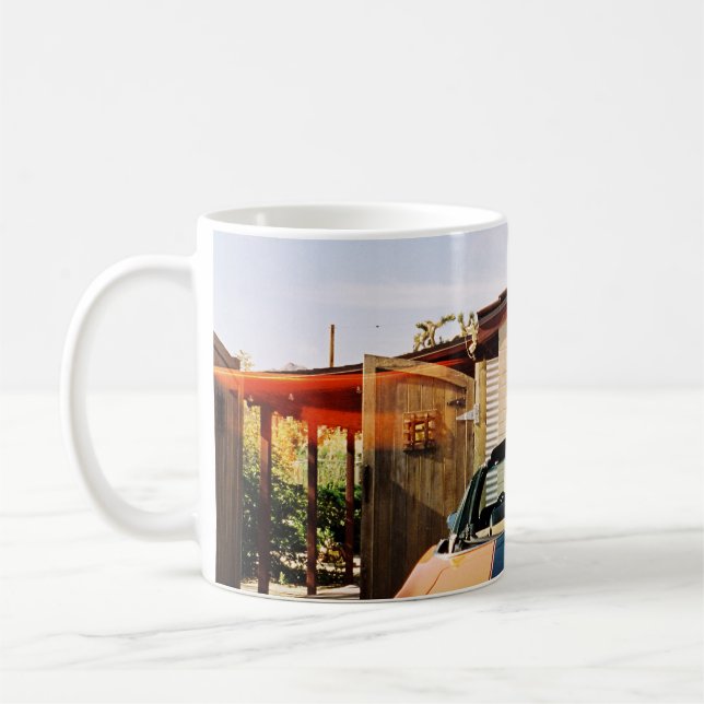 Blue car parked beside brown concrete building in  coffee mug (Left)