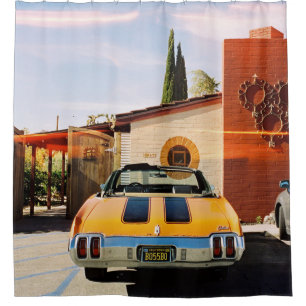 Blue car parked beside brown concrete building in  shower curtain