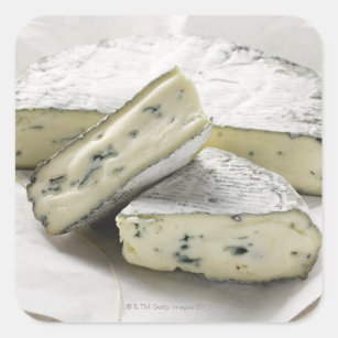 Blue cheese with pieces cut on paper square sticker