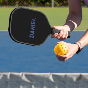 Blue custom name on black pickleball paddle