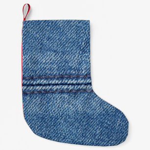 Blue denim background close-up (macro) small christmas stocking