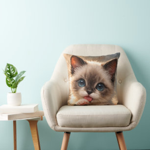 Blue-Eyed siamese,   Kitten licking its Paw Cushion